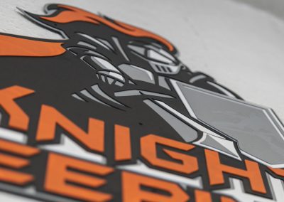 Closeup of a custom metal sign for Knight Sweeping, Inc.