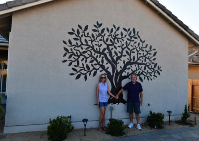 couple posing front of custom metal art made by Stites Manufacturing