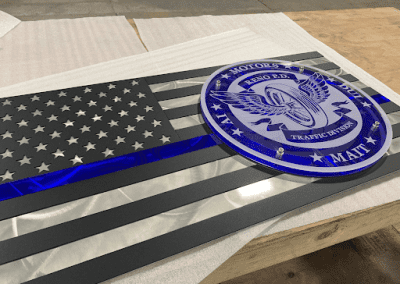 Metal sign in the shape of a flag for a local police department