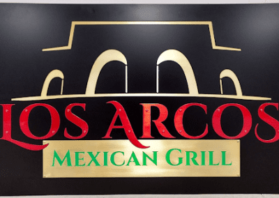 Closeup of a metal sign for Los Arcos Mexican Grill